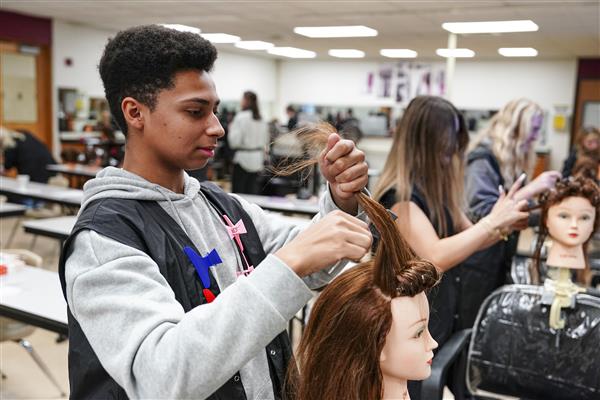 Cosmetology  students working on Mannequins 